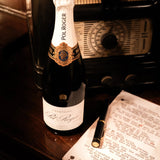 The Pol Roger pen resting on a speech beside Pol Roger champagne